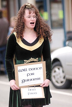 Sira Stenberg with the Blanchette School of irish Dance walks along C Street in Virginia City during the St. Patrick&#039;s Day Parade with her &quot;will dance for Guinness&quot; sign, in reference to a dark Irish Beer Sunday. Photo by Brian Corley