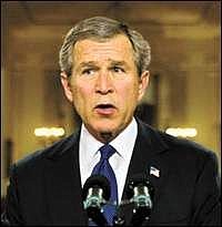 President Bush stands in the White House Cross Hall after addressing the nation on his ultimatum to Iraqi leader Saddam Hussein, in Washington, Monday, March 17, 2003.  (AP Photo/J. Scott Applewhite)