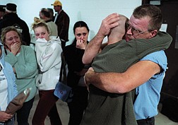 eJoseph Smith, right, hugs his son Spc. Adam Smith before he deployed along with about 55 others from the Nevada Army National Guard&#039;s 777th Engineer Utilities Team Company early Tuesday, March 18, 2003 in Henderson, Nev.  Behind them are friends and family. (AP Photo/Las Vegas Review-Journal, John Locher)
