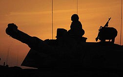 A Scots Dragoon Guard takes a break after a long night of fighting in southern Iraq, Monday March 24, 2003. (AP Photo/Tony Nicoletti, Pool)