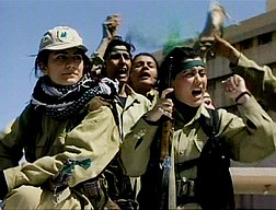 Kurdish women fighters, seen in this image from video, cheer as they drive through the streets of Kirkuk, Iraq, Thursday, April 10, 2003. Kurdish fighters poured into the Iraqi oil city of Kirkuk on Thursday, facing little resistance as they captured one of the two main prizes of the northern front. (AP Photo/APTN)