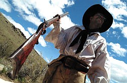 Ray Anderson, aka &#039;9 Fingers&#039; stands with his Hawkins rifle at the opening of the Mountain Man Rendezvous Friday in Carson City.  The event will run through Sunday.