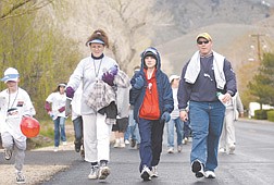 (From right) Joe Kingsland, Carissa Carmazzi and Bobbie Paul walk during the March of Dimes walk that started at the Capitol early Saturday morning. Carmazzi watches Andrew Harris skip along.