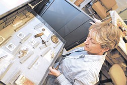 Nevada State Museum Collections Manager Alanah Woody opens a drawer that holds a collection of items that were found in Lovelock&#039;s former Chinatown and date back to    the late 1800&#039;s.  The items will be on display in the basement of the museum next week during Nevada Archaeolog Awareness and Historic Preservation Week. photo by Rick Gunn