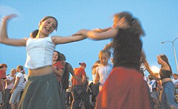Veronica Jenks, 11, of South Lake Tahoe, from left, and Lauralee Bell, 13, of Gardnerville, dance Friday evening in the parking lot of the Carson Mall.