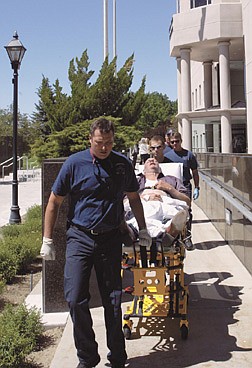 Nevada Assemblyman Tom Collins, D-North Las Vegas, is taken by paramedics from the Legislative Building in Carson City, Nev., after collapsing on the Assembly floor Monday, June 30, 2003. Collins complained of chest pains and will be under observation at Carson-Tahoe Hospital for 24 hours, preventing him from voting on a tax package by the midnight deadline. (AP Photo/Las Vegas Review-Journal, K.M. Cannon)
