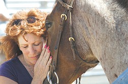 Cheryl Konrath of the  California Drill Team named Cowgirl Way  shows affection for her newly adopted horse Dakota Wednesday afternoon. Members drill team from Norco California attended the Warm Springs Correctional Center&#039;s horse training facility to get to know the horses they have adopted from the facility.  Photo by Rick Gunn