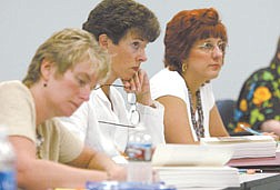 Western Nevada Community College students, from left, Artha Dutcher, Cathy Eckart and Laura Jarett listen during their English class on Monday afternoon.