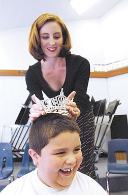 Music teacher Christina O&#039;Neil tries her Miss Nevada crown on first-grader Fernando Mata-Izquierdo, 6, during class Tuesday. O&#039;Neil let students try on the crown before leaving today to compete in the Miss America pageant. Photo by Rick Gunn.