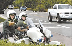 Traffic officers from the Carson City Sheriff&#039;s Department, from left, Sgt. Mike Cullen and Dep. Bill Richards, work the intersection of Winnie and Victoria Lanes on Wednesday afternoon after complaints from residents about ongoing problems with speeders in the area.