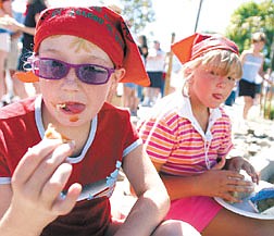 Taylor Kimbal, 8, of Reno, left, and Hannah Lehman, 7, of Reno, eat hot dogs instead of lamb during the Basque Festival at Fuji Park Sunday.