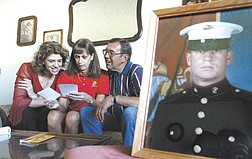 Marine Cpl. Larry Brown&#039;s family look through photos of his welcome home party held over Labor Day weekend after his 7-1/2 month deployment in Iraq.  From left, Brown&#039;s sister Karri Couste, mom Sally Brown-Bliss and step-father Dean Bliss, at their Carson CIty home on Wednesday, say Brown will be getting out of the Marines in November.