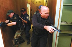 Luke Elliott, of The Walker River Police Department , right,     prepares to enter a room at the Stewart facility during a Counter Drug Task Force Training in Carson City Thursday. Ellliott was flanked by Carson City Sheriff&#039;s Deputy Jason Gault, Nevada Highway Patrol State Trooper Paul Hales , and  and Bret Allred of Iron City Utah. &#124; photo by Rick Gunn