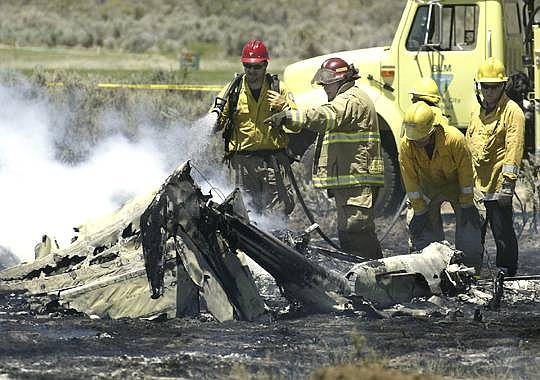 Cathleen Allison/Nevada AppealCrews extinguish burning debris from  a fatal plane crash near Eagle Valley West Golf Course.