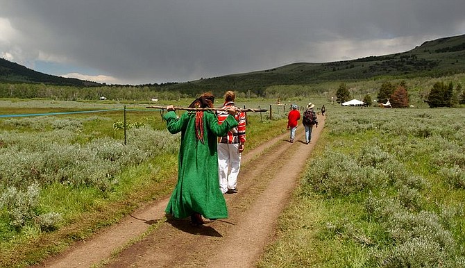 **  ADVANCE FOR SUNDAY JULY  4  ** Rainbow Family participants walk on a path which separates villages Wednesday, June 30, 2004, in the Modoc National Forest, Calif. The remote counterculture event culminates Sunday as thousands of hippies and followers of unorthodox religions hold hands in a circle and silently pray for world peace from dawn until noon. (AP Photo/Ben Margot)