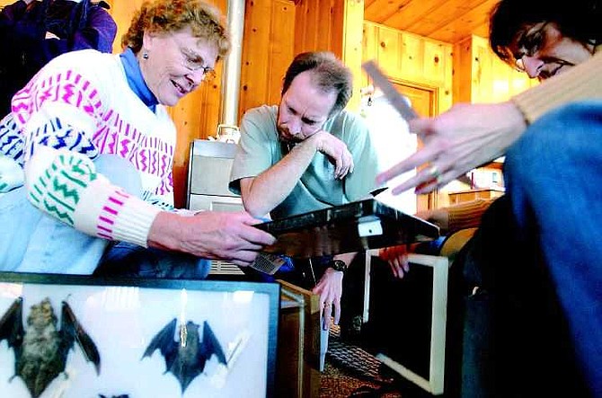 BRAD HORN/Nevada Appeal Barbara Lowal, from left, looks at bats with Michael Bish and Phyllis Atkinson at the Silver Saddle Ranch in Carson Saturday morning.