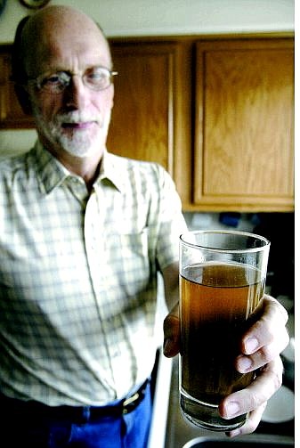 Cathleen Allison/Nevada Appeal Emory Alexander shows a glass of water at his north Carson City home on Monday.  The city water department told him it was probably safe to drink but he could boil it if he&#039;d feel safer.