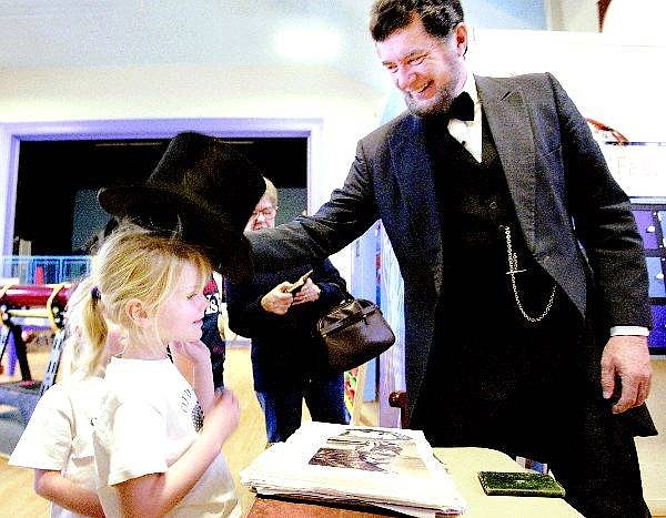 Cathleen Allison/Nevada Appeal Wally Earhart who portrays Abe Lincoln, jokes with Mikaila Wilde, 4, of Minden on Monday at the Children&#039;s Museum of Northern Nevada. Earhart told tales of that brought President&#039;s Day to life.