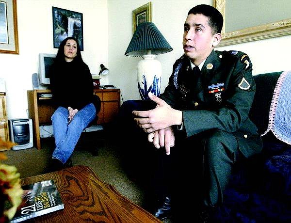 Cathleen Allison/Nevada Appeal Denise Madera, left, listens as her son, Army Pfc. Joseph Madera, talks about his duty in Iraq from his family home in Carson City on Monday morning.