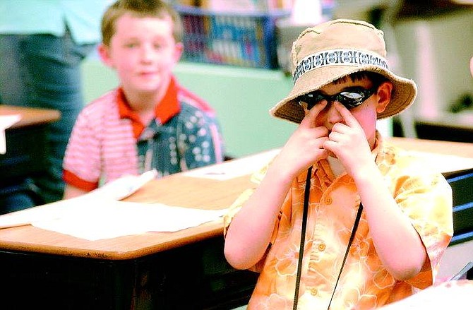 Rick Gunn/Nevada Appeal 7-year-old Hank Bingham adjusts his shades in class at Bethelehem-Lutheran school Tuesday. It is Lutheran week and the students are celebrating with different themes. Tuesday&#039;s theme included the students dressing up as tourists.
