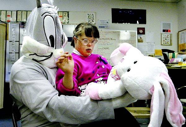 Cathleen Allison/Nevada Appeal Kimmy Bates, 12, gets a surprise gift from the Easter Bunny Wednesday afternoon. The Easter Bunny visited special education students at Fremont Elementary School as part of a program sponsored annually by Carson area SBC Telecom Pioneers.