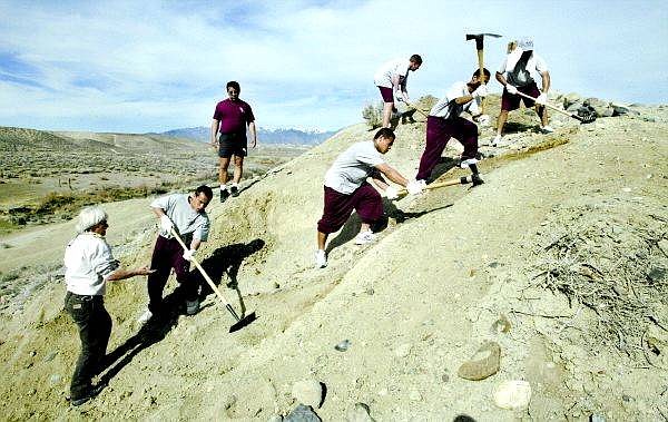 Cathleen Allison/Nevada Appeal Bureau of Land Management Outdoor Recreation Planner Fran Hull, bottom left, directs a group of Rite of Passage students working to rehabilitate a hillside trail on Sunday morning in Wilson Canyon.  A group of about 40 volunteers worked over the weekend to help restore areas of the campground near Yerington.