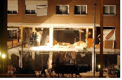 Associated Press Firefighters in a crane,  examine the damage after three suspected terrorists who were sought in connection with March 11 Madrid bombings, blew themselves up in a building that was surrounded by police in Legenes, near Madrid, Spain, Saturday.  One special forces agent was killed and 11 police officers were injured in the operation. The fete of the suspects is unknown at this time.