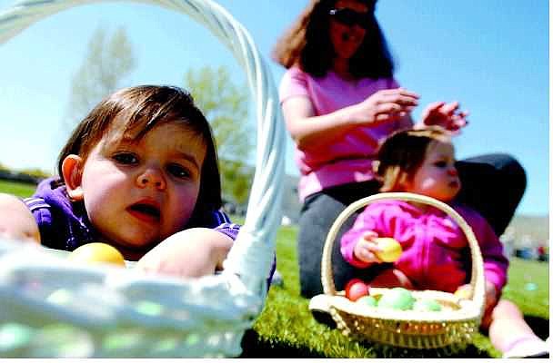 BRAD HORN/Nevada Appeal Megan Dressler, 15 months old, of Stagecoach, puts eggs in her basket while her mother plays with her twin during the children&#039;s first Easter egg hunt at Governor&#039;s Field on Sunday.