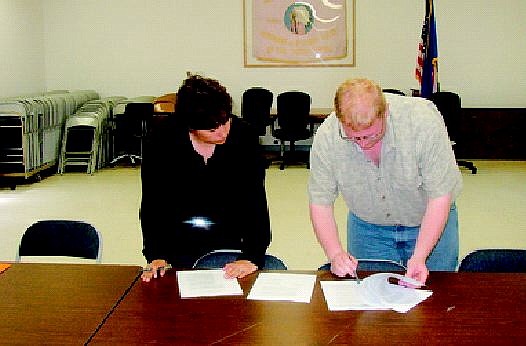 Walker River Paiute Tribal Chairwoman Victoria Guzman, left, and Boys and Girls Club of Mason Valley Executive Director Travis Crowder go over paperwork in agreement of a partnership to start a Boys and Girls Club in Schurz on American Indian land.