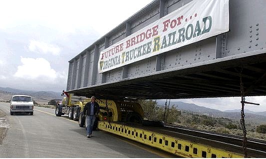 Brad Horn/Nevada Appeal Driver Ron Bunker, of Las Vegas, walks to the back of his trailer after hauling this 105,000-pound piece of the Virginia &amp; Truckee Railroad bridge from Hawthorne to Carson City, Saturday.