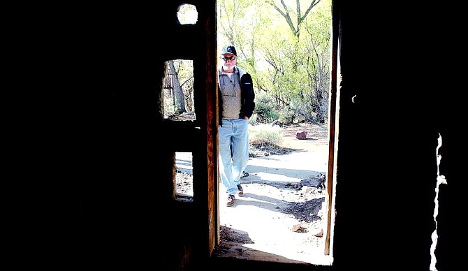 BRAD HORN/Nevada Appeal Paul Chelew, of Dayton, looks inside a storage area at the Rock Point Mill during a tour Sunday morning.