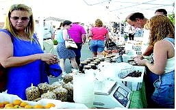 Shoppers browse the goods at one of Fallon&#039;s farmers&#039;  markets last year. The markets will return every Tuesday starting June 15 on Maine Street. File photo