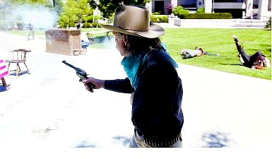 BRAD HORN/Nevada Appeal Nevada Gunfighter Glenn Crowder, also known as Henry Van Sickle, shoots on the Legislative lawn during the annual Kit Carson Trail Wild West Tour on Saturday afternoon.