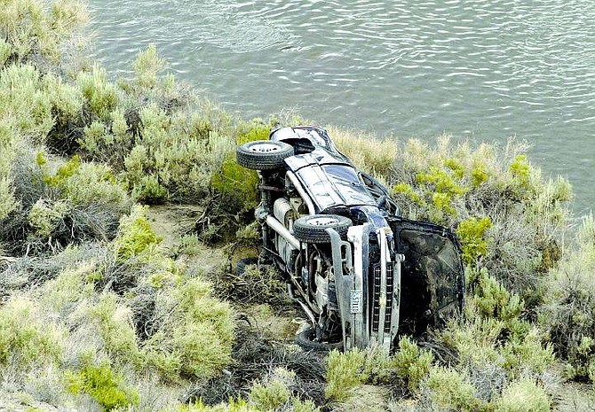 Cathleen Allison/Nevada Appeal Washoe County Sheriff&#039;s officials investigate the scene of an accident near Wadsworth, where Brenda Scott&#039;s truck was located down an embankment near the Truckee River.