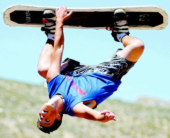 BRAD HORN/Nevada Appeal Dan Pera, a stunt man with Xtreme Air, performs a backflip on a snowboard at the Xtreme Air show at Fuji Park on Saturday afternoon.