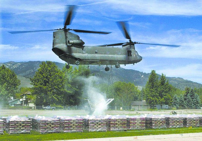 Cathleen Allison/Nevada Appeal An Army National Guard CH47D Chinook helicopter had successfully delivered one load of cement to the C-Hill project Monday morning before the transporting platform broke.  The load of 9,000 pounds of bags of cement was just a few feet off the field at Carson Middle School when the structure buckled.
