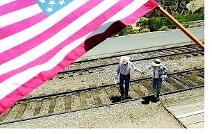 JohnD  Winters and his wife, Kay walk across the tracks to catch the train for the beginning of the Crown Point Mill tour Sunday  afternoon.  	BRAD HORN/Nevada Appeal