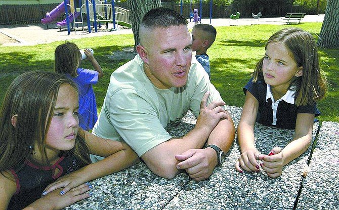 Cathleen Allison/Nevada AppealBrian Morton sits with his 10-year-old daughters Alyssa, left, and Hailey at Mills Park Tuesday.  His younger children, Sierra, 4, and Collin, 6, play in the background. Hailey must undergo life-saving heart surgery in July, and Morton doesn&#039;t qualify for catastrophic leave. His co-workers are trying to raise money to help the family.
