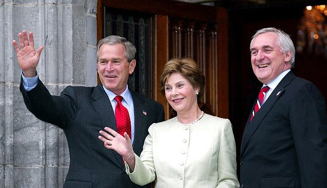 US President Bush and first lady Laura Bush wave with Irish Prime Minister Bertie Ahern, right, at Dromoland Castle in Co. Clare western Ireland Friday June 25, 2004 at the start of the European Union/US summit meeting. The EU/US meeting runs until Saturday. (AP Photo/Martin Cleaver )
