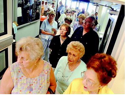 BRAD HORN/Nevada Appeal Inge Erikson, from left front, Helen Self and Dorie Pharris wait in line during the grand opening of the expansion at the Carson City Senior Citizens Center on Thursday morning.