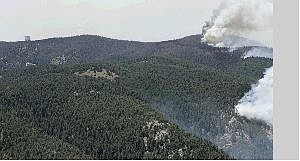 Associated Press Wildfires on Mount Graham near Safford, Ariz., burn near the Large Binocular Telescope, upper left, Monday.