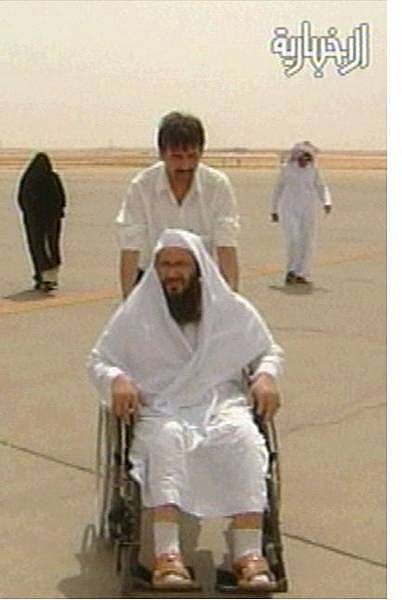 ** RETRANSMISSION FOR ALTERNATE CROP ** Khaled bin Ouda bin Mohammed al-Harby is pushed in a wheelchair after arriving to the Riyadh, Saudi Arabia airport in this image made from television Tuesday, July 13, 2004. Al-Harby, a confidant of Osama bin Laden, surrendered to Saudi diplomats in Iran and was flown to the kingdom Tuesday. He is the most important figure to surface under an amnesty promising to spare the lives of militants who turn themselves in. (AP Photo/Al Ekbariya via APTN)** TV OUT  SAUDI ARABIA OUT **