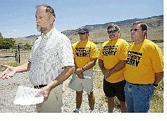 Retired U.S. Forest Service employee Robert McDowell, left, is flanked by firefighters, from left, William Steward, Tim Lucich and Chris Ketring, during a news conference on the Kerry-Edwards Forest Plan in Reno on Tuesday.  Associated Press