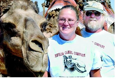 Diane and Gary Jackson, below, of the Nevada Camel Co. in Stagecoach, with their camel Michael. Above, a young girl awaits a camel ride Tuesday.