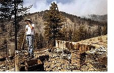 Hugh Fenwick looks over the remains of his home in the Timberline subdivision above Carson City.