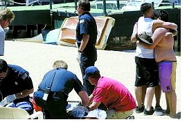 Dan Thrift/Appeal News Service Friends and family console each other while emergency personnel perform CPR on the younger of two victims involved in a personal watercraft accident Monday at Lake Tahoe.