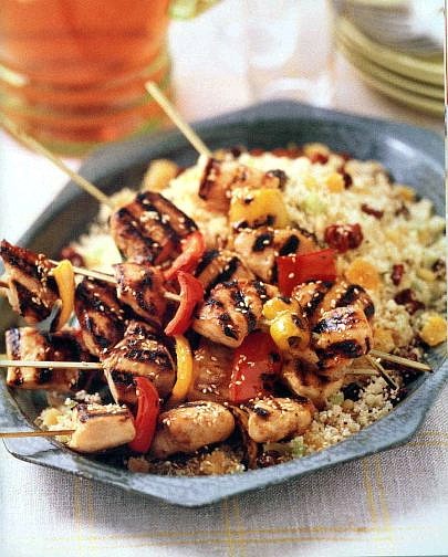 Associated Press Chicken Kebabs Over Fruited Couscous has a bright range of seasonings that makes the spicy grilled chicken a nice balance for fruited couscous.