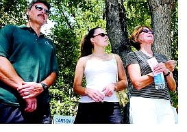 BRAD HORN/Nevada Appeal John Staub, left. his daughter, Lindsay, and wife, Judy, listen to the tribute to the firefighters. Their Kings Canyon Road home was lost in the Waterfall fire.
