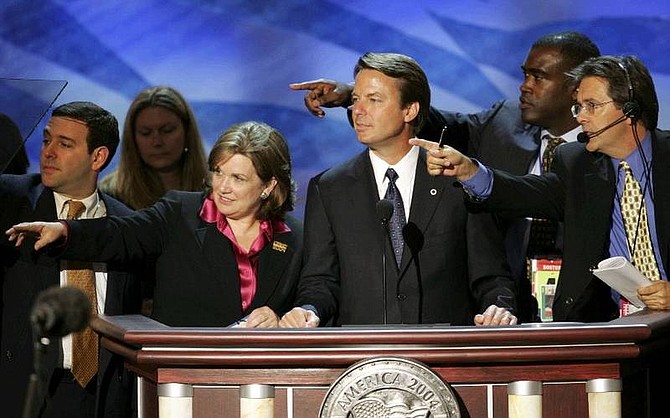 Vice presidential candidate John Edwards gets directions from convention staffers and his wife, Elizabeth, left, before rehearsing a speech Tuesday, July 27, 2004, at the FleetCenter in Boston after the day&#039;s session of the Democratic National Convention. Edwards is scheduled to speak to the delegates Wednesday night. (AP Photo/Ron Edmonds)