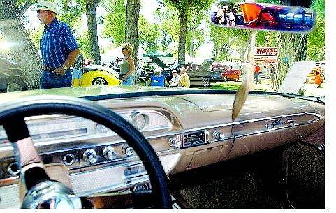 A view from the inside of Dayton resident Chuck Martens&#039; 1962 Ford Galaxie 500XL convertible, left, at the Silver Dollar Car Classic at Mills Park on Saturday afternoon. Above, Vanity license plates are sold at the entrance to Mills Park on Saturday during the annual show.